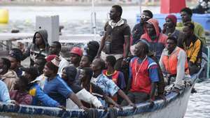 epa11609733 Rescued migrants arrive in a small boat at the port of Los Cristinaos, southern Tenerife Island, Canary Islands, Spain, 17 September 2024. Maritime Rescue has rescued 54 men who were on board a cayuco in the sea, 17 kilometers from the coast of Tenerife.  EPA/Alberto Valdes