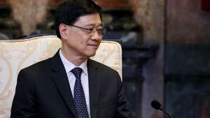 epa11514387 Hong Kong Chief Executive John Lee Ka-Chiu listens to Vietnam’s President To Lam (not pictured) as they meet at the Presidential Palace in Hanoi, Vietnam, 01 August 2024. Lee is on an official visit to Vietnam from 31 July to 01 August 2024.  EPA/LUONG THAI LINH
