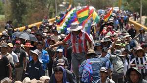 epa11691078 Supporters of former Bolivian president Evo Morales march on a blocked road in Parotani, Bolivia, 29 October 2024. For 16 days, Morales' supporters have been blocking roads to demand the withdrawal of legal proceedings for rape and human trafficking against the former president, along with demands for a solution to the economic situation and the defense of the official leader's presidential candidacy for 2025.  EPA/LUIS GANDARILLAS