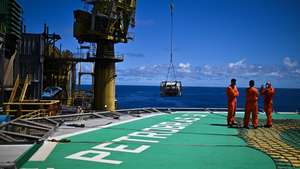epa11696333 Employees on the P-51 platform of Brazilian oil company Petrobras in the Marlim Sul field, in the Campos Basin, off the northern coast of the State of Rio de Janeiro, Brazil, 31 October 2024 (issued 01 November 2024). Petrobras has launched a revitalization project to extend the life and increase production in the Campos offshore basin, which used to be its largest oil province and is now, just days away from the 50th anniversary of its discovery, considered a mature field.  EPA/Andre Borges