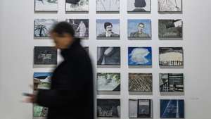 epa10484134 A man walks by several artworks belonging to Henrique Faria collection at ARCO Madrid International Contemporary Art Fair at IFEMA Madrid fair ground, in Madrid, Spain, 22 February 2023. ARCOmadrid fair celebrates its 42nd edition from 22 to 26 February 2023 with the participation of 218 galleries and The Mediterranean Sea as the central theme.  EPA/Rodrigo Jimenez