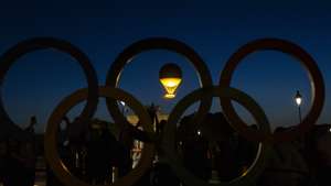 epa11504690 The Olympic cauldron attached to a balloon rises up into the air at the Jardin des Tuileries next to the Louvre Museum, during the Paris 2024 Olympic Games, in Paris, France, 28 July 2024. The Paris Olympic Games 2024 run from 26 July to 11 August.  EPA/ANDRE PAIN