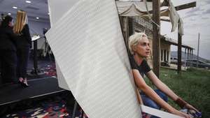 epa09574916 A photograph of Halyna Hutchins, the cinematographer killed on the set of 'Rust', on display as a news conference is held by the Dordick Law Corporation to announce the filing of a lawsuit in the Los Angeles Superior Court at the Marriott Hotel in Los Angeles, California, USA, 10 November 2021. The lawsuit is against 'Rust' Movie Production LLC, 'Rust' armorer Hanna Gutierrez-Reed, 'Rust' Assistant Director David Halls, 'Rust' actor Alec Baldwin and others, alleging punitive, and other damages.  EPA/CAROLINE BREHMAN