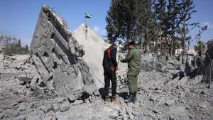 epa11971287 Syrian security forces inspect a destroyed building a day after an Israeli airstrike struck the city of Daraa in southern Syria, 18 March 2025. At least three people were killed and dozens were wounded in the airstrike late 17 March, Syrian state news agency SANA reported.  EPA/MOHAMMED AL RIFAI