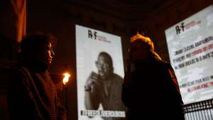 epa09808502 Canele Bernard (L), the sister of Olivier Dubois speaks to press next to a monumental projection for French journalist Olivier Dubois on Pantheon building in Paris, France, 07 March 2022. The monumental projection is implemented by Reporters Sans Frontieres (Reporters Without Borders) on the Pantheon for the 47-year-old Olivier Dubois who has kidnapped in Gao, Mali on 08 April 2021.  EPA/Mohammed Badra