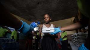 epa11396673 People wait to receive food from the World Food Program (WFP) on the Isidor Jean Louis College in Port-au-Prince, Haiti, 05 June 2024 (Issued 07 June 2024). In the central kitchen of the World Food Program (WFP) in the Haitian capital of Port-au-Prince, employees work against a clock to combat hunger preparing meals for delivery to camps, where thousands of families await food, which is sometimes the only meal of the day for many of them. One such shelter is the Isidor Jean Louis College, situated in the center of Port-au-Prince hosting 600 refugees for several months following the abandonment of their homes due to the violence perpetrated by armed gangs.  EPA/ORLANDO BARRIA