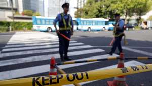 epa11667961 Police officers block access to the scene where a vehicle crashed into a fence in front of the prime minister's office in Tokyo, Japan, 19 October 2024. In the early morning hours, a man threw Molotov cocktails toward the Liberal Democratic Party (LDP) headquarters and crashed his car into a fence at the Prime Minister's Office. According to the Metropolitan Police Department, the man was arrested on the spot, and no one was injured.  EPA/FRANCK ROBICHON