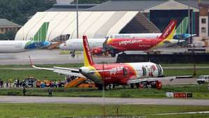 epa08484482 An Airbus A321neo airplane of Vietnamese carrier VietJet Air sits on a grass field after skidding off the runway due to heavy rain, at Tan Son Nhat International Airport in Ho Chi Minh, Vietnam, 14 June 2020. No injuries were reported.  EPA/STR