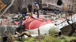 epa12174861 Indian workers remove the wreckage of the Air India passenger plane with the help of a crawler crane from the crash site, near Sardar Vallabhbhai Patel International Airport in Ahmedabad, Gujarat state, western India, 14 June 2025. Air India flight AI171, bound for London carrying 242 passengers and crew members on board a Boeing 787-8 aircraft, crashed minutes after take-off in the Meghaninagar area of Ahmedabad on 12 June.  EPA/RAJAT GUPTA