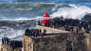 epa10959632 Crowds watching the big waves during a free surfing session at Praia do Norte, in Nazare, Portugal, 05 November 2023. The Nazare surfing spot in Portugal is one of the world's biggest wave spots in winter time.  EPA/JEAN-CHRISTOPHE BOTT