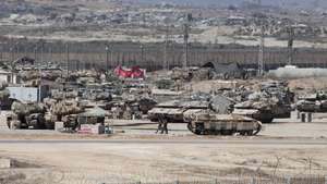 epa12345927 Israeli soldiers with military vehicles gather at a position near the border fence with the Gaza Strip, as seen from the Israeli side of the border, in southern Israel, 02 September 2025. Israel's military said it is stepping up logistical and operational preparations ahead of expanded combat operations and a large-scale mobilization of reservists.  EPA/ABIR SULTAN