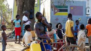 A woman talking on her cell phone to relatives in the village of Buzi, after the passage of cyclone Idai, in the province of Sofala, central Mozambique, 27 March 2019. Reports state that some 1.7 million people are said to be affected across southern Africa. TIAGO PETINGA/LUSA