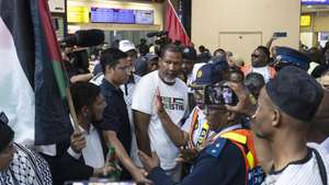 epa12439076 Nkosi Zwelivelile 'Mandla' Mandela (C), grandson of Nelson Mandela, who was among the six South African nationals and flotilla activists detained by Israeli forces, upon his return home at the O. R. Tambo International Airport, in Johannesburg, South Africa, 08 October 2025. The six South African activists, who had been detained by Israeli forces while participating in the Global Sumud Flotilla humanitarian mission to Gaza, returned to South Africa via Jordan.  EPA/KIM LUDBROOK