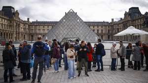 epa12466944 Visitors stand outside a closed Louvre Museum a day after a robbery in Paris, France, 20 October 2025. The Louvre Museum was targeted in a robbery by several criminals who smashed windows to steal eight priceless royal pieces of jewelry on 19 October. The Louvre remains closed for a second day running. French Culture Minister Rachida Dati called it 'an attack on France’s cultural heritage.'  EPA/YOAN VALAT