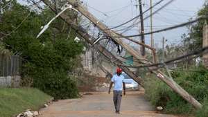 epa12494421 A person walks down a street affected by Hurricane Melissa; in Santa Cruz, Jamaica, 30 October 2025. The Caribbean Public Health Agency (CARPHA) pledged to provide essential supplies to Jamaica after Hurricane Melissa, a category 5 storm, hit the southwestern part of the country on Tuesday. At least 19 people are dead, more than 70 percent of customers remain without electricity and 134 roads are blocked in Jamaica due to the destruction caused by Hurricane Melissa.  EPA/Orlando Barría