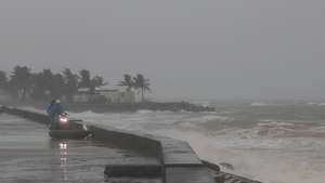 epa12507317 People watch waves crashing on the beach ahead of Typhoon Kalmaegi in Cua Dai, Da Nang, central Vietnam, 06 November 2025. The typhoon is expected to make landfall in Vietnam on 07 November 2025.  EPA/DAU TIEN DAT