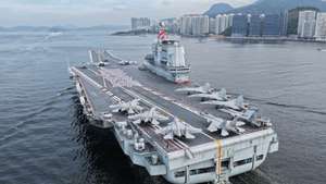 epa12211828 Officers and soldiers spelling out Chinese characters 'secure country, sweet home' on aircraft carrier Shandong's flight deck in Hong Kong waters, China, 03 July 2025. A fleet of the Chinese People's Liberation Army (PLA) Navy led by the aircraft carrier Shandong arrived in the Hong Kong Special Administrative Region (HKSAR) on 03 July morning, kicking off a five-day visit. The aircraft carrier and the Yan'an missile destroyer were anchored near the west end of the Victoria Harbor, while the Zhanjiang missile destroyer and the Yuncheng missile frigate docked at the PLA Hong Kong Garrison's naval base in Stonecutters Island. This is the Shandong's first visit to Hong Kong. From Friday to Sunday, the Shandong, the Zhanjiang and the Yuncheng will host open tours, lectures, drill demonstrations and other exchange activities.  EPA/XINHUA / LIU FANG CHINA OUT / UK AND IRELAND OUT  /       MANDATORY CREDIT EDITORIAL USE ONLY