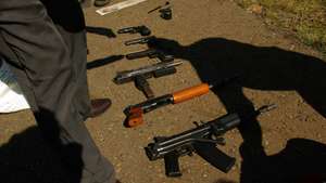 epa01986087 FILE The file image dated 16 April  2004 shows police collecting a variety of firearms found after they pulled over a suspicious looking vehicle which turned out to be on their way to commit a robbery near Johannesburg,South Africa  11 January 2010. Eleventh of January 2010 marked the start of a government backed amnesty which  will run until 11 April 2010 and allows people to hand in illegal, unregistered firearms at any police station, without fear of prosecution.  EPA/STR