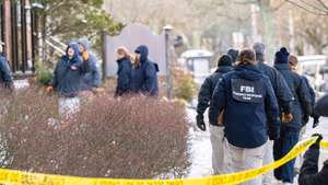 epa12595325 FBI agents investigate blocked off buildings near The Barus and Holley building at Brown University in Providence, Rhode Island, USA, 15 December 2025. The gunman remains at large following the 13 December shooting that killed two and injured nine others in an academic building on the Brown University campus.  EPA/MEL MUSTO