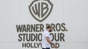 epa12471315 A person walks by the Warners Bros. studio tour location at the Warner Bros. Studio Lot in Burbank, California, USA, 21 October 2025. Warner Bros. Discovery revealed in a press release on 21 October that it is putting the company up for sale.  EPA/CAROLINE BREHMAN