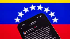 epa12623106 Illustration of a statement by US President Donald Trump posted on his Social Truth profile, pictured with the Venezuelan flag in the background, in Prague, Czech Republic, 03 January 2026. US President Trump announced that a 'large-scale strike' on Caracas resulted in the capture of Venezuelan leader Nicolas Maduro and his wife, who were reportedly flown out of the country. The Venezuelan government denounced the US operation as a 'grave military aggression'.  EPA/MARTIN DIVISEK