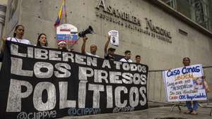 epaselect epa12725715 People hold signs during a demonstration in front of the National Assembly in Caracas, Venezuela, 10 February 2026. The National Assembly (AN, Parliament) and Venezuela's Program for Coexistence and Peace assured that they will continue to receive proposals from relatives of political prisoners as part of the public consultations on the amnesty bill proposed by the acting president of the South American country, Delcy Rodriguez.  EPA/MIGUEL GUTIÉRREZ