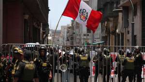 epa12750957 A person holds a Peruvian flag during a demonstration against interim president Jose Jeri in front of the Peruvian Congress in Lima, Peru, 17 February 2026. The Peruvian Congress began a special session to discuss seven motions of censure filed against Jeri, which could lead to the eighth presidential change in the Andean country in nearly a decade of political instability.  EPA/Paolo Aguilar