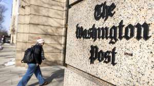 epa12704535 A person walks outside The Washington Post headquarters in Washington, DC, USA, 04 February 2026. The storied paper has announced a massive round of layoffs affecting roughly 30 percent of its workforce, approximately 300 employees across the company.  EPA/JIM LO SCALZO