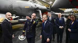 epa12781585 Ship commander Captain Thomas Puga (2-L) guides Swedish Prime Minister Ulf Kristersson (3-L), French Foreign Minister Jean-Noël Barrot (L) and Swedish Foreign Minister Maria Malmer Stenergard (R) among the fighter jets on the hangar deck before the bilateral meeting on the French aircraft carrier Charles De Gaulle (R91) at the quay in the North Port in Malmo, Sweden, 27 February 2026.  EPA/JOHAN NILSSON  SWEDEN OUT