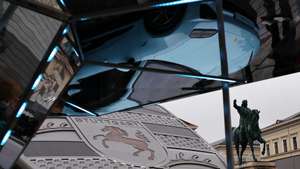 epa12367185 A Porsche Macan 4 is reflected at the Porsche pavilion with the Statue of Maximilian I seen in the background at the IAA Open Space in the city center at the International Motor Show Germany IAA Mobility 2025 in Munich, Germany, 10 September 2025. The IAA Mobility 2025 takes place in Munich from 09 to 14 September 2025, featuring numerous world premieres and a special focus on electric mobility and digitization.  EPA/ANNA SZILAGYI