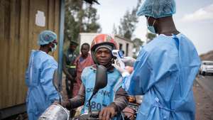 epaselect epa12997409 Health workers in protective gowns and masks check locals’ temperature as a preventive measure against Ebola in Kanyaruchinya, near Goma, North Kivu, Democratic Republic of Congo, 27 May 2026. The World Health Organization (WHO) has declared the Ebola outbreak, caused by the Bundibugyo virus, in the Democratic Republic of the Congo a public health emergency of international concern.  EPA/MARIE JEANNE MUNYERENKANA