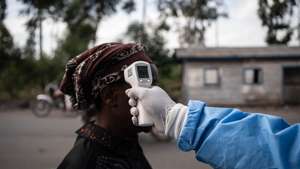 epaselect epa12997411 A health worker in a protective gown and mask checks locals’ temperature as a preventive measure against Ebola in Kanyaruchinya, near Goma, North Kivu, Democratic Republic of Congo, 27 May 2026. The World Health Organization (WHO) has declared the Ebola outbreak, caused by the Bundibugyo virus, in the Democratic Republic of the Congo a public health emergency of international concern.  EPA/MARIE JEANNE MUNYERENKANA