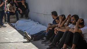 epa13016306 Relatives of Abdallah Abu Kaloub and his wife sit near their covered bodies at Al-Shifa Hospital in Gaza City, Gaza Strip, 04 June 2026. The couple was killed during overnight Israeli airstrikes on Gaza, which the Palestinian Ministry of Health stated killed at least nine Palestinians, including women and children.  EPA/MOHAMMED SABER