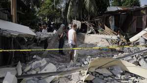 epa13026192 People inspect the damage at the site of a collapsed wall separating a warehouse-type facility and several homes, a day after an earthquake, in General Santos City, southern Philippines, 09 June 2026. The National Disaster Risk Reduction and Management Council (NDRRMC) is verifying collected reports that 36 people have died and four others are missing in parts of southern Philippines following a 7.8 magnitude earthquake that struck on 08 June.  EPA/CERILO EBRANO