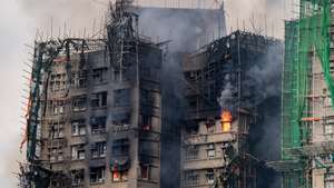 epa12551667 Smoke billows from an apartment fire in the Tai Po district of Hong Kong, China, 27 November 2025. The fire, which started on 26 November, has killed at least 44 people, and left 279 missing.  EPA/LEUNG MAN HEI