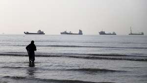 epa13009259 A handout photo made available by Isna News Agency shows an Iranian woman watching cargo ships stuck in the Strait of Hormuz, along the coast of Bandar Abbas, in southern Iran, 01 June 2026. According to Iranian state media, the military's central command warned all vessels to secure Islamic Revolution Guards Corps (IRGC) Navy clearance to pass through the strait or face maritime security risks.  EPA/AMIRHOSSEIN KHORGOOEI/ ISNA NEWS AGENCY HANDOUT RESTRICTIONS: NO Access Israel Media/Persian Language TV Stations Outside Iran/Strictly No Access BBC Persian/VOA Persian/Manoto TV/Iran International TV. (As mandated by Iran's Directorate General for Foreign Media) -- HANDOUT EDITORIAL USE ONLY/NO SALES