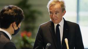 epa09922193 LVMH Moet Hennessy Louis Vuitton CEO Bernard Arnault (R) speaks to the press following his meeting with Japanese Chief Cabinet Secretary Hirokazu Matsuno (not pictured) at the Prime Minister's Office in Tokyo, Japan, 02 May 2022.  EPA/Hiro Komae / POOL