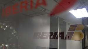 epa12545022 An Iberia airline logo outside one of its offices in the Cristal Park Tower in Caracas, Venezuela, 23 November 2025. The cancellation of flights to Venezuela by several airlines follows an advisory by the US Federal Aviation Administration (FAA) urging extreme caution when flying over the country and the southern Caribbean Sea amid a US military build-up in the region.  EPA/MIGUEL GUTIERREZ