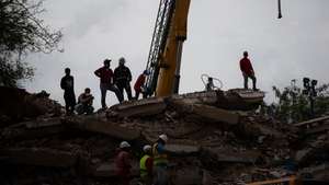 epa13089424 Volunteers and rescue staff work at a building brought down by the double earthquake in Catia La Mar, Venezuela, 05 July 2026. Eleven days after the double earthquake struck the country, efforts are focused on clearing debris from collapsed buildings in La Guaira state, while search and rescue operations scale back. The two earthquakes of magnitude 7.2 and 7.5 struck Venezuela on 24 June 2026.  EPA/Ronald Pena R