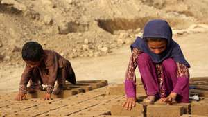 epa13061775 Afghan children work at a brick kiln in Kandahar, Afghanistan, 24 June 2026. The International Labour Organization has described a system in Afghan brick kilns in which advances on future wages can trap families in bonded labor, while UNICEF reported that 1 in 5 children aged 5-17 in Afghanistan is engaged in child labor.  EPA/QUDRATULLAH RAZWAN