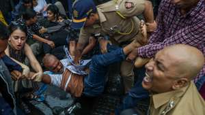 epaselect epa13123152 Indian police personnel detain a supporter of the Cockroach Janta Party (CJP) during a protest in Mumbai, India, 20 July 2026, demanding Union Education Minister Dharmendra Pradhan's resignation over alleged examination paper leak irregularities. The youth-led movement organized the march after police forcibly removed and hospitalized activist and educator Sonam Wangchuk over health concerns following his three-week hunger strike.  EPA/DIVYAKANT SOLANKI