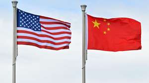epa13093320 The flags of the United States and China are seen during Independence Day celebrations at the National Stadium in Honiara, Solomon Islands, 07 July 2026.  EPA/MICK TSIKAS AUSTRALIA AND NEW ZEALAND OUT