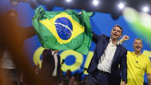 epa13132810 Brazilian Senator Flavio Bolsonaro (2R) reacts during the national convention of Brazil's Liberal Party (PL) in Sao Paulo, Brazil, 25 July 2026. The Liberal Party, led by former President Jair Bolsonaro, kicked off its national convention to nominate his eldest son, Senator Flavio Bolsonaro, as its candidate for the upcoming presidential election in October 2026.  EPA/ISAAC FONTANA