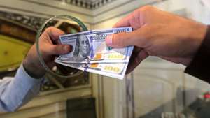 epa10817490 A foreign currency dealer exchanges US Dollars at a money exchange company in Peshawar, Pakistan, 24 August 2023. The US dollar on 24 August reached record high against Pakistani rupee at Rs317 mark in open market during intraday trading. The Pakistan Rupee continues to slump after the National Assembly was dissolved, handing over the powers to the caretaker Prime Minister Anwaarul Haq Kakar. The continuous free fall of rupee is narrowing gap between the interbank and open mark rates, one of the conditions laid forth by the International Monetary Fund (IMF) for its bailout package.  EPA/BILAWAL ARBAB