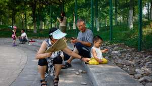 epa10802325 An elderly couple takes care of a baby at a park in Beijing, China, 16 August 2023. China's fertility rate dropped to a record low of 1.09 in 2022 from data released by China's Population and Development Research Center. China, which has reported a decline in its population for the first time since 1961, has the lowest fertility rate among nations with a population exceeding 100 million such as Hong Kong, Singapore, South Korea and Taiwan.  EPA/MARK R. CRISTINO