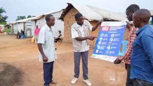 epa13190908 Medical staff and volunteers explain Ebola virus prevention measures to refugees in the CECA camp in Mambasa, Ituri province, Democratic Republic of Congo, 25 August 2026. The local branch of the New Civil Society of Congo (Nouvelle Societe Civile du Congo SOCICO) reported that delays in laboratory results are fueling community resistance to Ebola response measures, compounded by ongoing insecurity in the area.  EPA/DIEUDONNE DIROLE