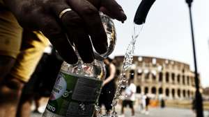 epa13196790 Tourists fill bottles with drinkin water from as fountain as they visit the Colosseum in Rome, Italy, 28 August 2026. Italy’s Ministry of Health issued a red-level heat alert for Rome and multiple major cities across the country, warning of extreme temperatures.  EPA/ANGELO CARCONI