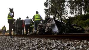 Bombeiros e elementos da GNR junto ao veículo colhido por um comboio de passageiros da Linha do Oeste junto à passagem de nível de Casal do Brejo, Caldas da Rainha 7 de julho de 2014. CARLOS BARROSO/LUSA