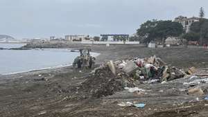 epa13285466 Municipal cleanup workers operate machinery to remove tons of waste and debris from Trampolin beach in Ceuta, Spain, 06 October 2026. Local services cleared approximately 222 tons of waste following a Spanish National Police evacuation operation that removed an estimated 3,000 migrants who had lived in makeshift camps on the beach for over two months following a mass border crossing in late July.  EPA/LAURA RINCON