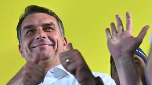epa13285943 Brazilian presidential candidate Flavio Bolsonaro reacts during the announcement of support from former conservative Goias Governor Ronaldo Caiado for the second round of the Brazilian elections, in Goiania, Brazil, 06 October 2026. The former governor called for defeating Lula's PT (Workers' Party) in the presidential runoff, amid chants of 'minister, minister, minister' from his supporters urging him to join a potential cabinet led by the far-right senator.  EPA/Andre Borges